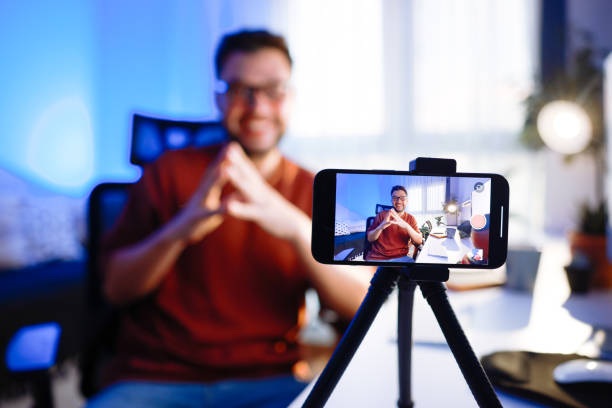 istock Smiling young male influencer doing a vlog post at home 2195908689