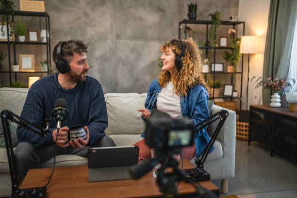 istock Joyful podcast show hosts record fresh podcast episode in home studio 2195909186