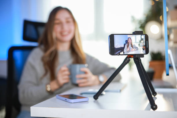 istock Smiling young female influencer doing a vlog post at home 2195909534
