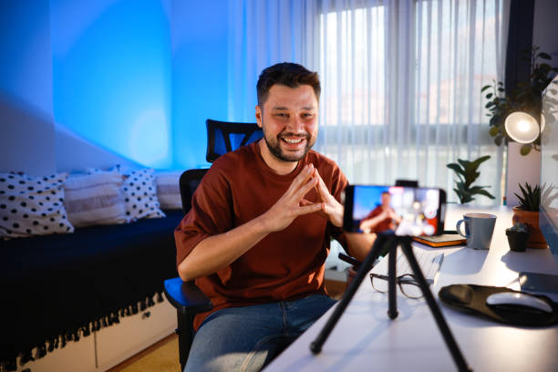 istock Smiling young male influencer doing a vlog post at home 2195909565