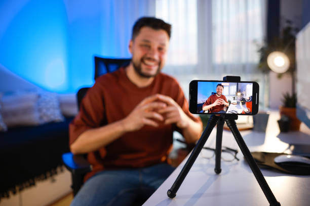 istock Smiling young male influencer doing a vlog post at home 2195910159