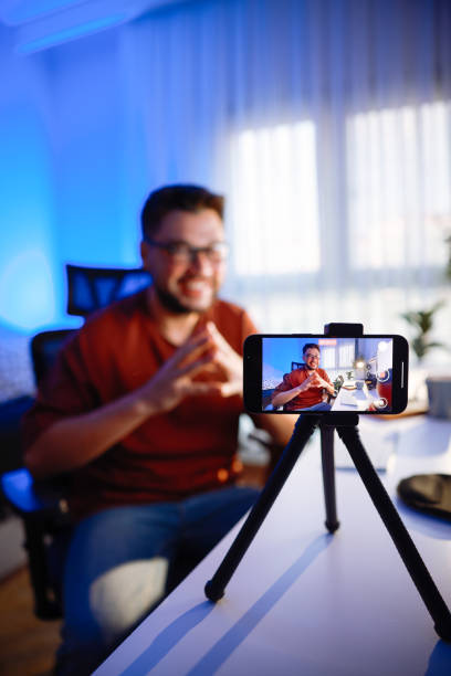 istock Smiling young male influencer doing a vlog post at home 2195910902