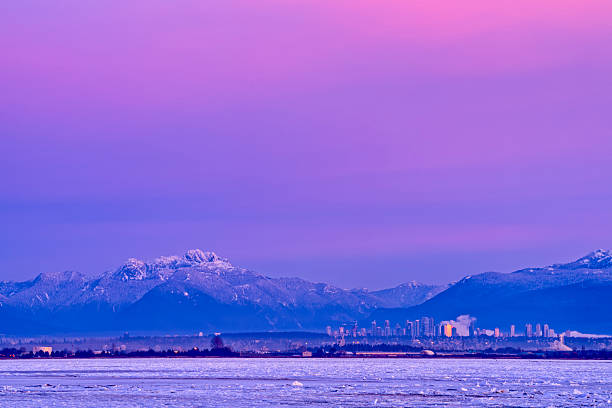 A winter view across the Boundary Bay area of the Fraser River Delta with the coastal mountains seen in the distance, British Columbia