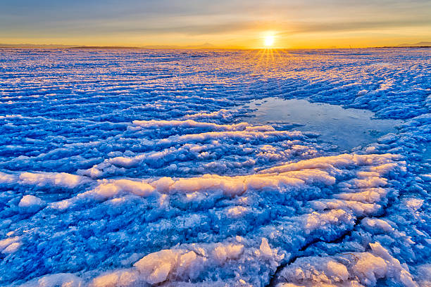 A beautiful winter landscape of frozem lake during the sunrise. Colorful scenery in Northern Europe.