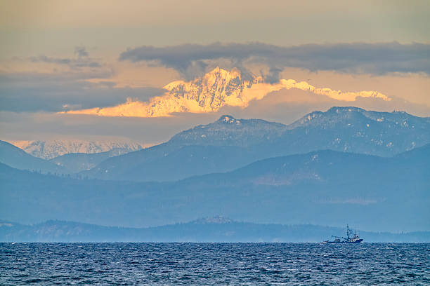 Fishing boat off Vancouver Island with view of Coastal Ranges, British Columbia