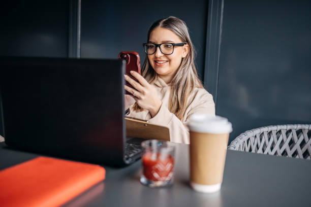 istock Young woman having drink alone at cafe and enjoying it while trying to study 2195914698