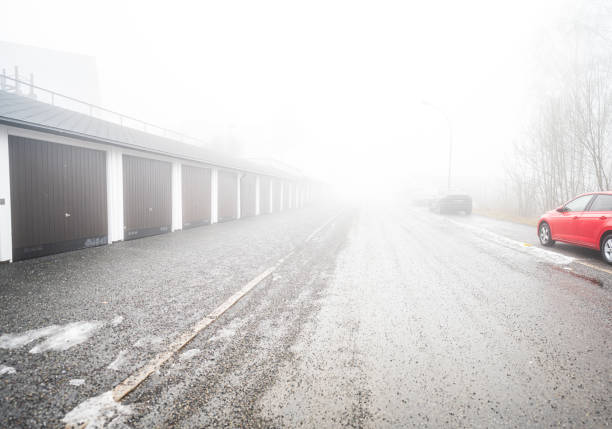 istock Car garages on a foggy day.. 2195914708