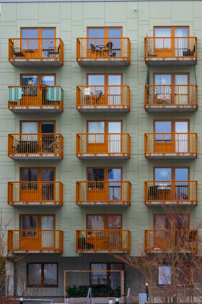 Orange balconies on a green apartment building.