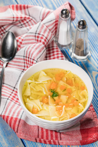 Broth - chicken soup with noodles in a bowl.