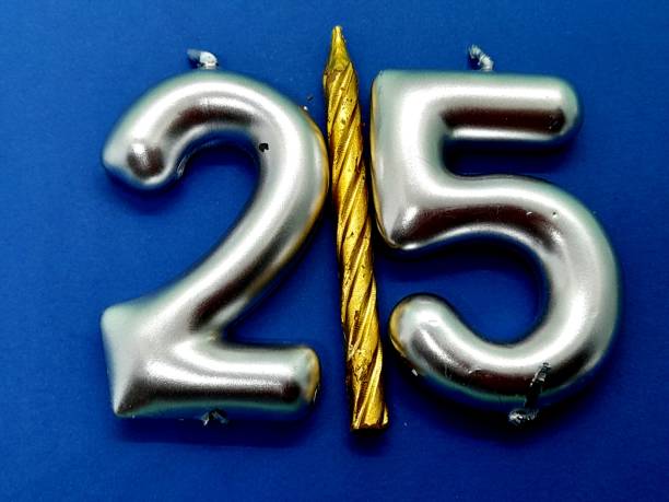 istock Number 25 birthday candle with blue background. 2195916289