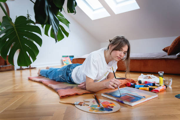 istock Young artist finds inspiration in the colors around her while creating with joy 2195916435