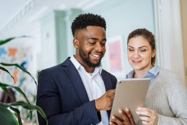 istock Group of diverse business people in office using technologies. Business people using digital tablet in the office and discussing investing opportunities 2195917200