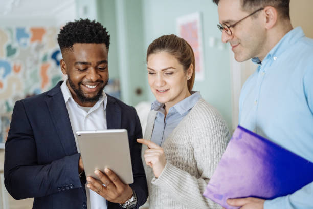 istock Group of diverse business people in office using technologies. Business people using digital tablet in the office and discussing investing opportunities 2195917201