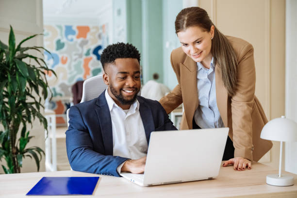 istock Group of diverse business people in office using laptop and having brainstorming session 2195917381