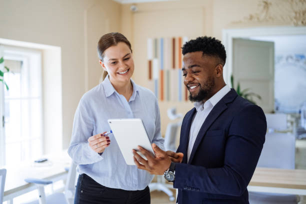 istock Group of diverse business people in office using technologies. Business people using digital tablet in the office and discussing investing opportunities 2195917801
