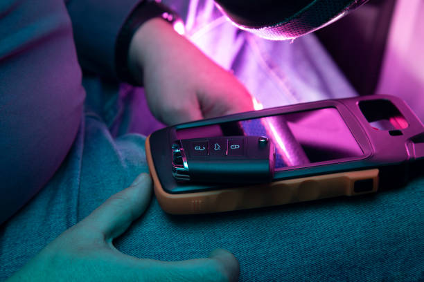 A cell phone is resting on a black bench next to a yellow dumbbell. The dumbbell is placed on a bench with a black cover. Placing weights on the smartphone broke the screen.