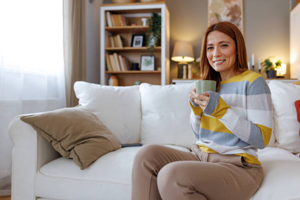 istock Woman relaxing on the sofa drinking a hot beverage at home 2195924057