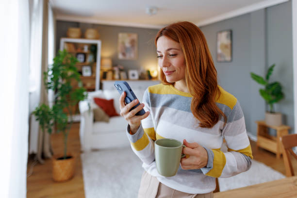 istock Woman enjoying morning coffee and using smartphone at home 2195924314