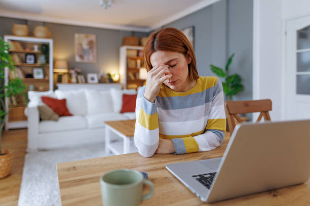 istock Stressed young woman having headache while working from home 2195924345