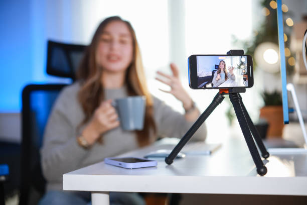istock Smiling young female influencer doing a vlog post at home 2195925218
