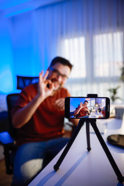 istock Smiling young male influencer doing a vlog post at home 2195925236