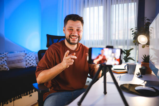 istock Smiling young male influencer doing a vlog post at home 2195925287