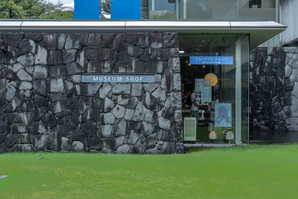Tokyo, japan, 09 27 2024: inviting museum shop exterior with stone walls and lush green grass, offering a peaceful shopping experience