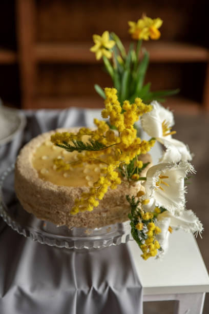istock Beautiful yellow cake decorated with fresh flowers on a table 2195927232