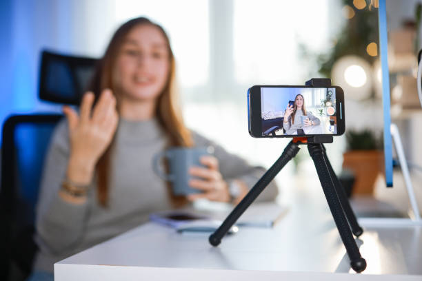 istock Smiling young female influencer doing a vlog post at home 2195927671