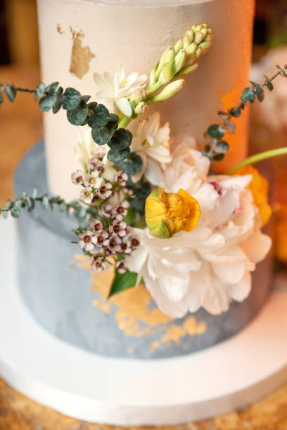 istock Beautiful cake decorated with fresh flowers on a table 2195928285