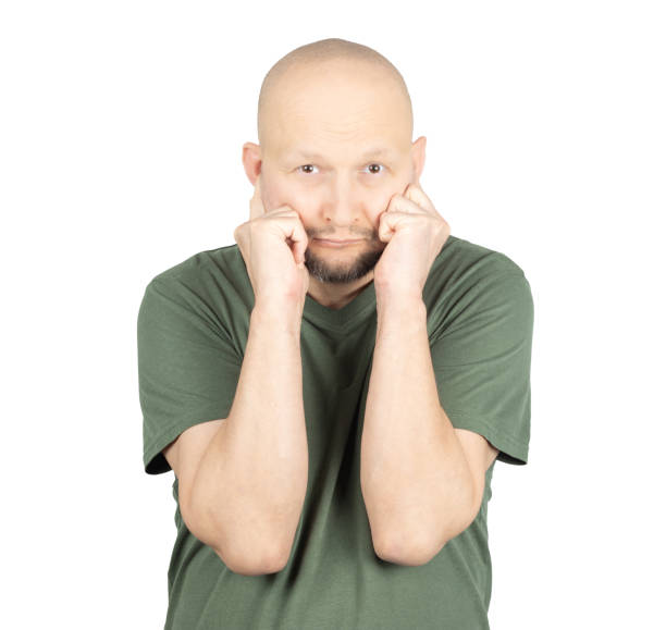 istock Worried man pressing his fists against his cheeks 2195928424