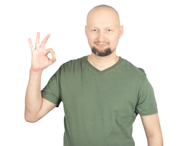 istock Smiling man making an OK hand gesture in studio portrait 2195928530