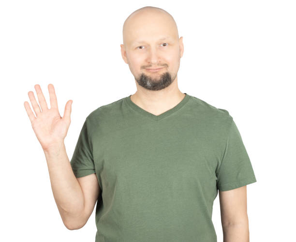istock Friendly bald man waving with a warm smile 2195928706