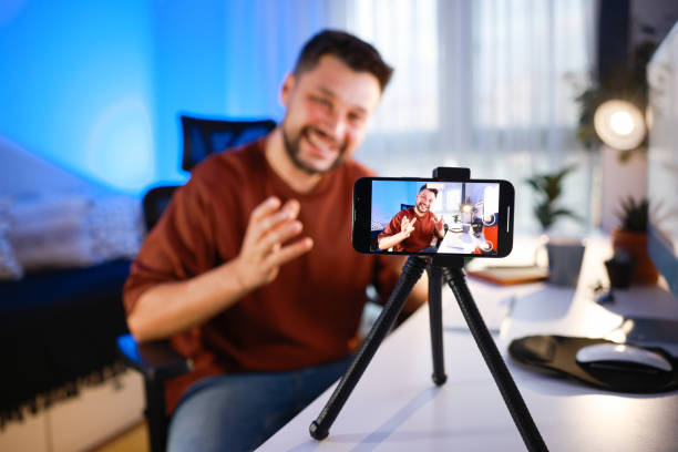 istock Smiling young male influencer doing a vlog post at home 2195928756