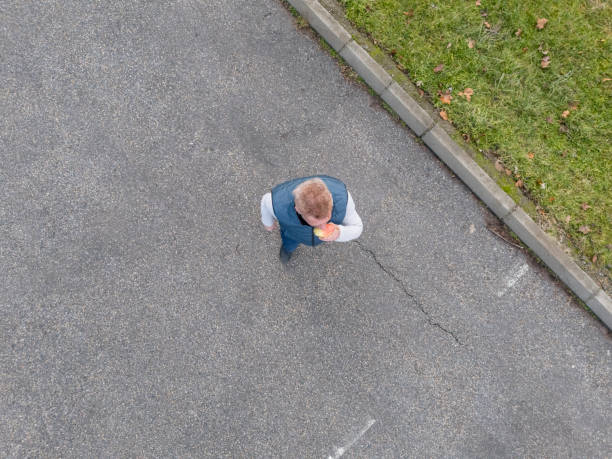 Man eats pear fruit while walk in the city