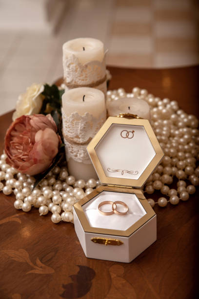 istock Wedding rings in a white box with candles and pearls 2195932039