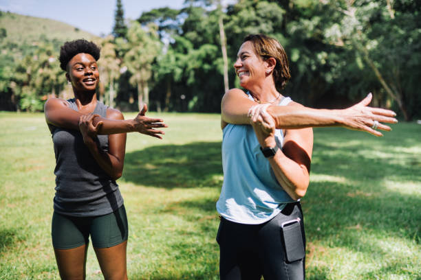 istock Women stretching at the park on a sunny summer day 2195932099