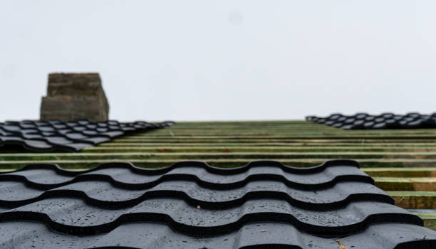 istock Masonry chimney and frame on which metal tile sheets lie 2195935380