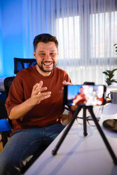 istock Smiling young male influencer doing a vlog post at home 2195936874