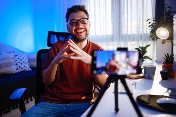 istock Smiling young male influencer doing a vlog post at home 2195937773
