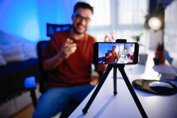 istock Smiling young male influencer doing a vlog post at home 2195937796