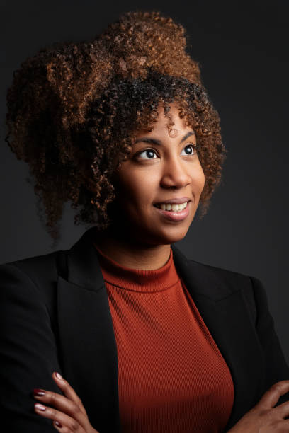 istock Confident black businesswoman in professional studio setting, smiling upward with ambition and career potential 2195938343