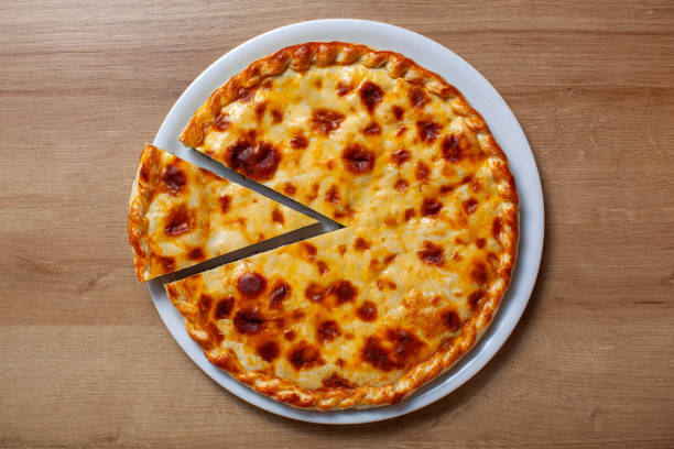 Delicious traditional Russian cheese pie on a white plate with two slices cut
