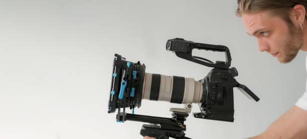 istock Videographer work studio cameraman man looks lens 2195941938