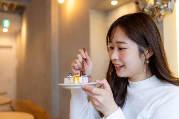 istock Female tourist eating cakes in cafe 2195944082