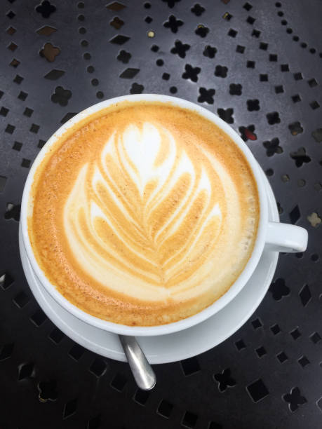 istock Latte with Foam Art on a Black Table 2195945221