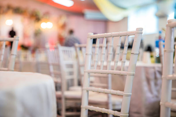 Guest chairs arranged neatly for a wedding ceremony, adorned with elegant decorations. Perfect for themes of celebration, hospitality, or event setup