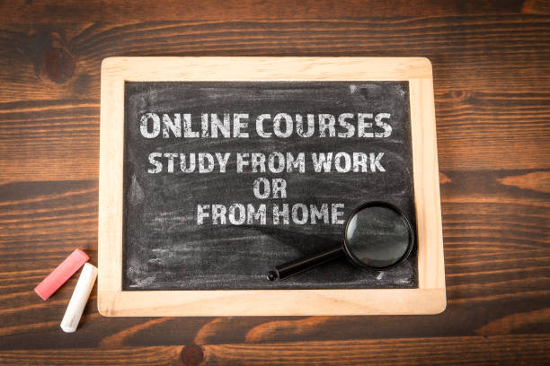 istock ONLINE COURSES, STUDY FROM WORK OR FROM HOME. Chalkboard on a wooden textured table 2195949486