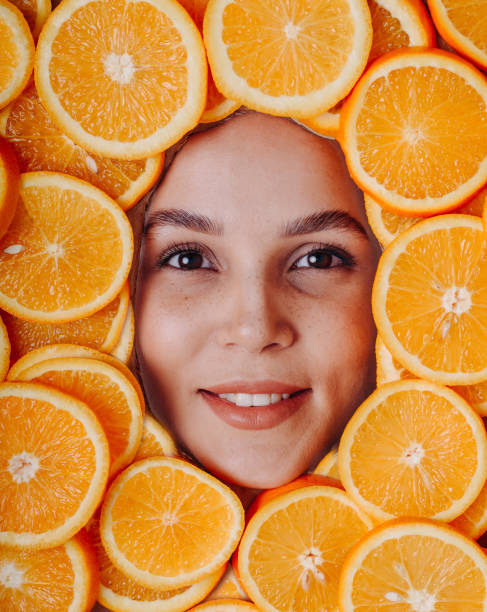 istock young woman with oranges 2195951655