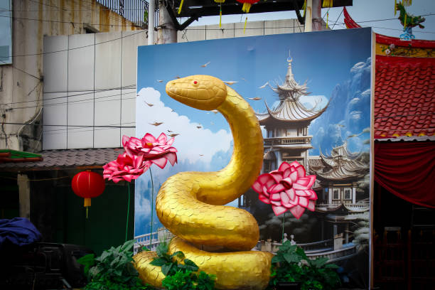 golden snake statue displayed with lotus flower decoration